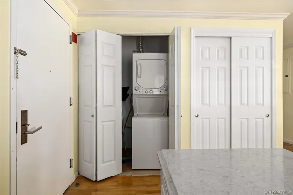 a view of a kitchen with a refrigerator and wooden floor