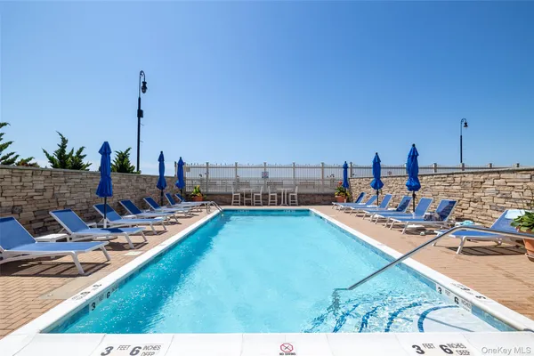 a view of a swimming pool with chairs