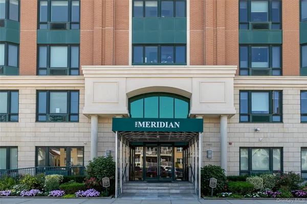 a front view of a building with a garden