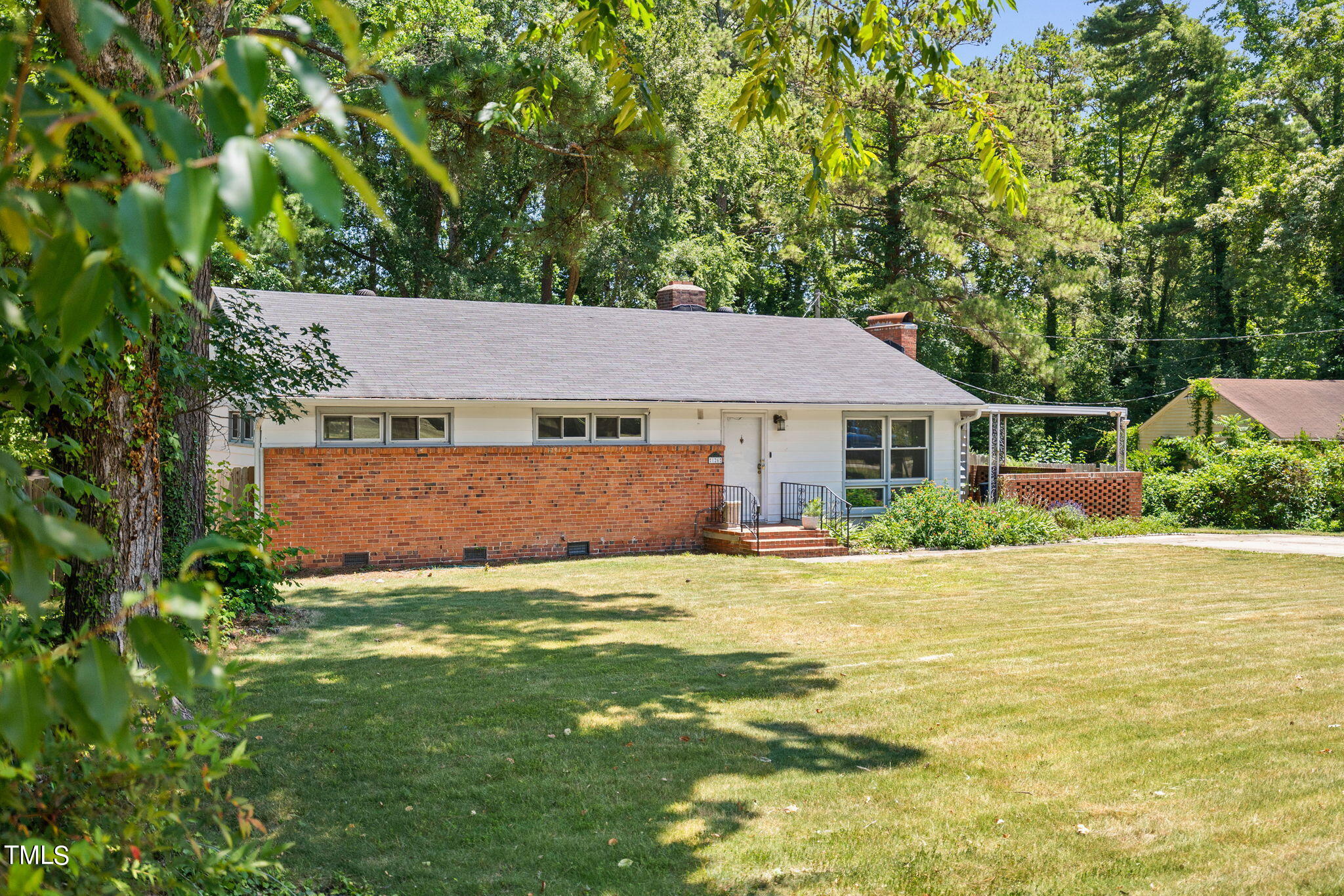 126 Clarendon Crescent Raleigh, NC 27610 - Photo 1 of 40 a front view of a house with a yard and trees