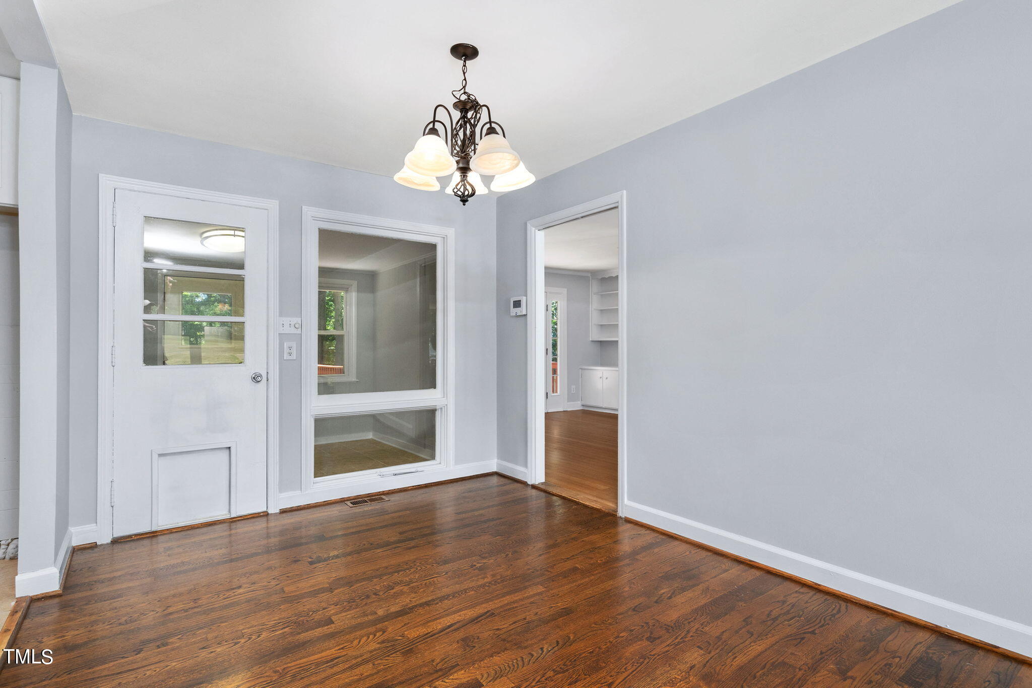 126 Clarendon Crescent Raleigh, NC 27610 - Photo 19 of 40 a view of a room with wooden floor and chandelier