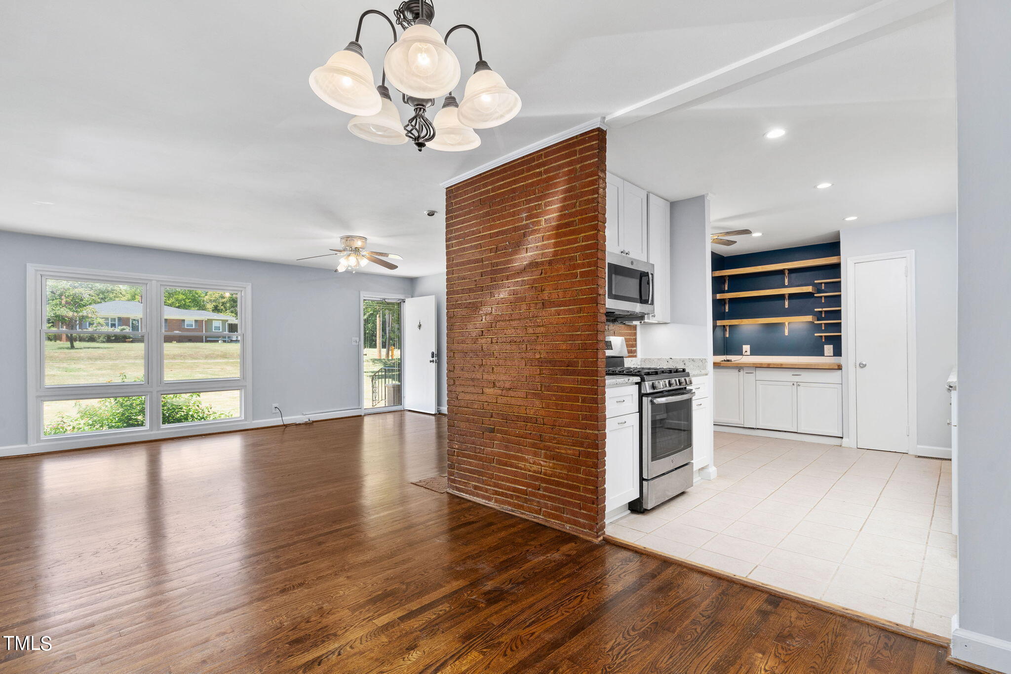 126 Clarendon Crescent Raleigh, NC 27610 - Photo 20 of 40 a kitchen with a refrigerator chandelier and a stove