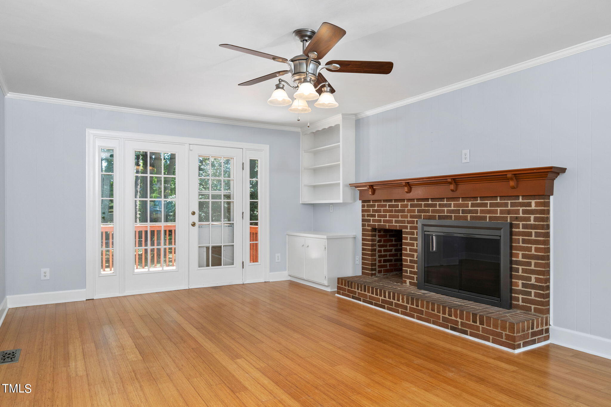 126 Clarendon Crescent Raleigh, NC 27610 - Photo 21 of 40 a view of an empty room with wooden floor fireplace and a window
