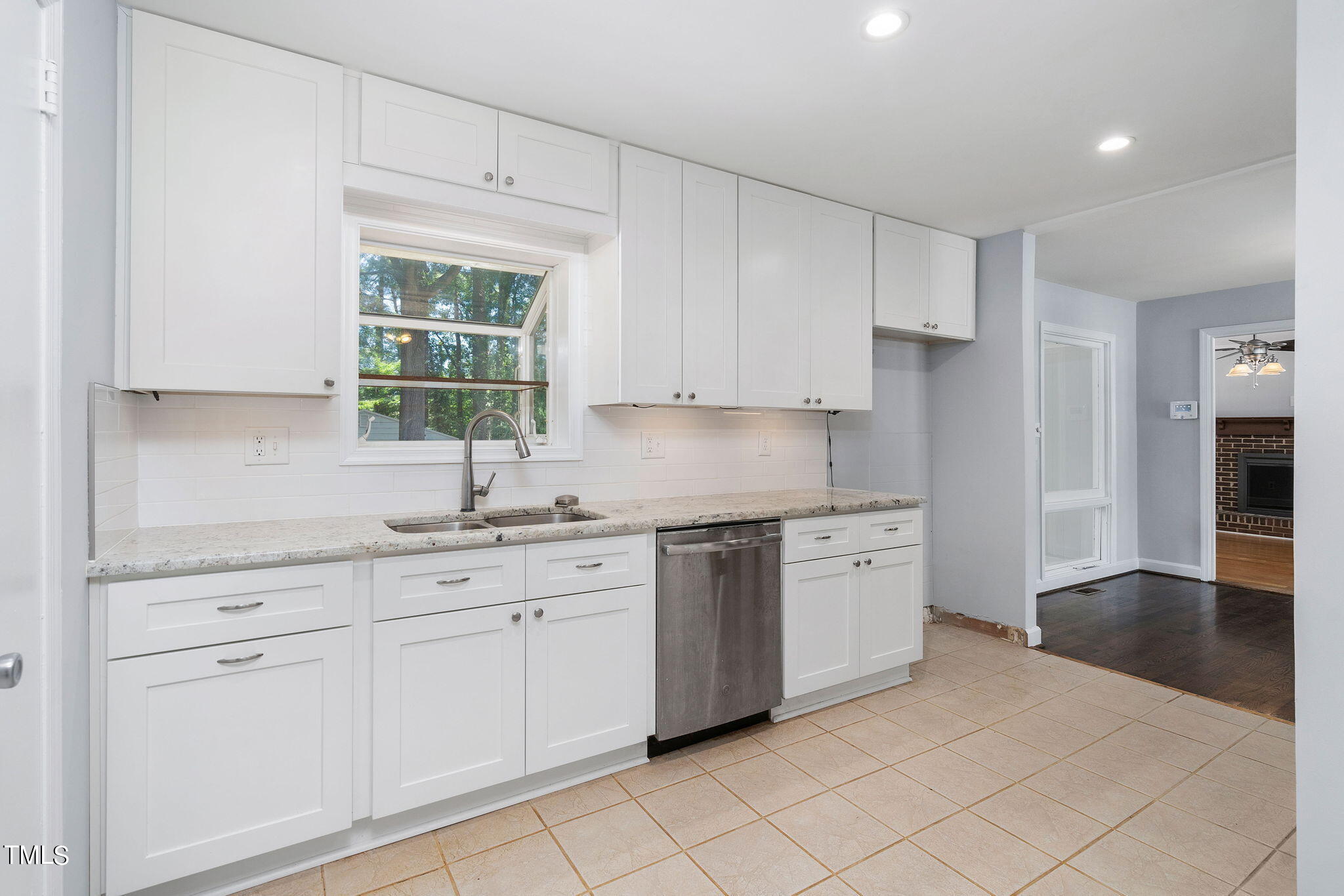 126 Clarendon Crescent Raleigh, NC 27610 - Photo 31 of 40 a kitchen with granite countertop white cabinets white appliances a sink and a window