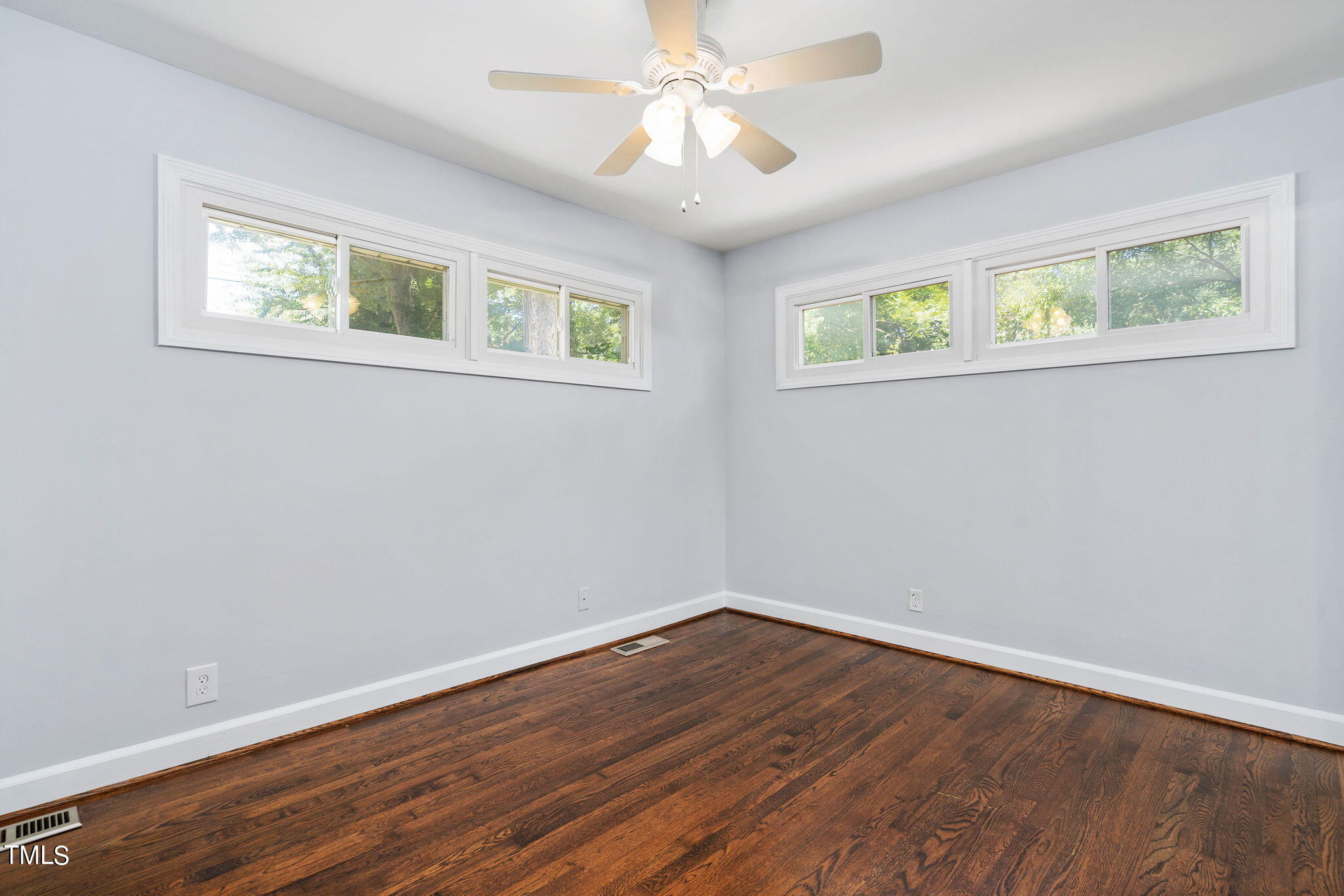 126 Clarendon Crescent Raleigh, NC 27610 - Photo 33 of 40 a view of an empty room with wooden floor and a window