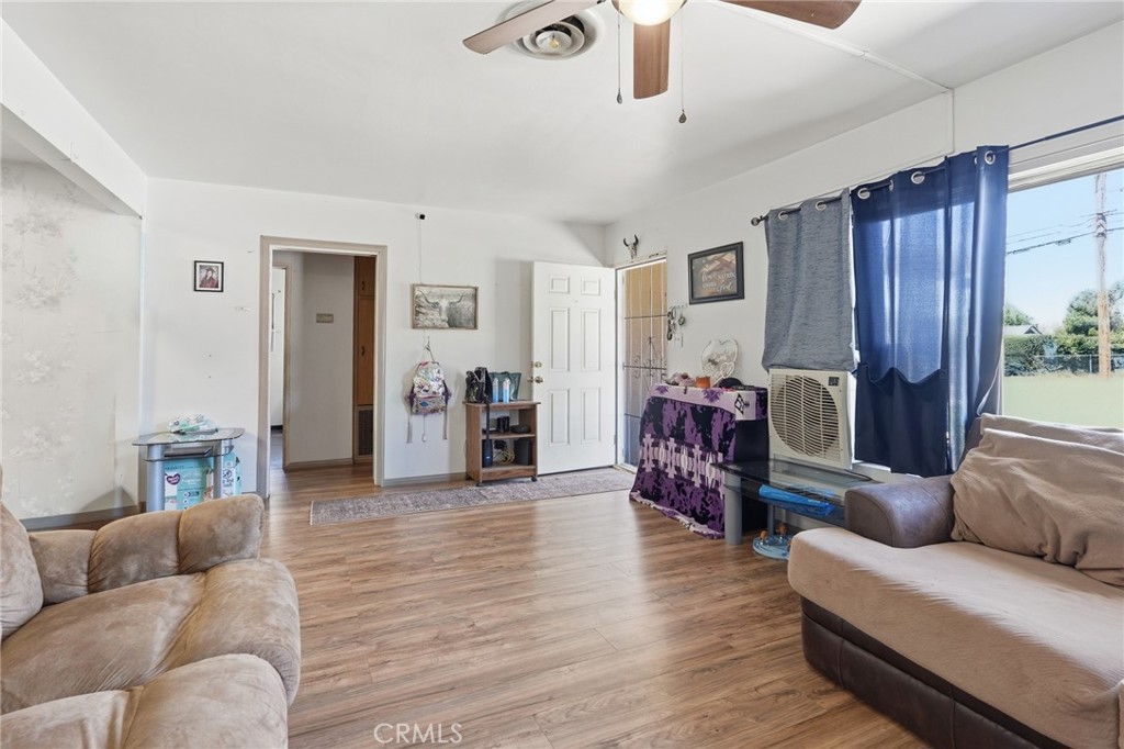183 East County Line Road Calimesa, CA 92320 - Photo 2 of 31 a living room with furniture and a wooden floor