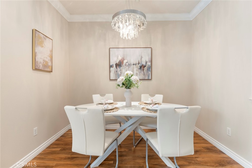 869 East Mountain Way, Unit D Azusa, CA 91702 - Photo 12 of 55 a view of a dining room with furniture wooden floor and a chandelier