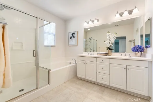 a bathroom with a tub sink shower and mirror