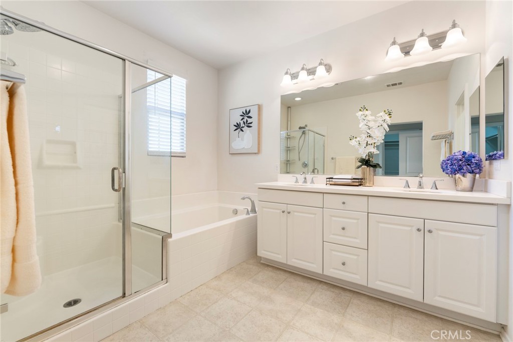 869 East Mountain Way, Unit D Azusa, CA 91702 - Photo 18 of 55 a spacious bathroom with a granite countertop sink a mirror a shower and a bathtub