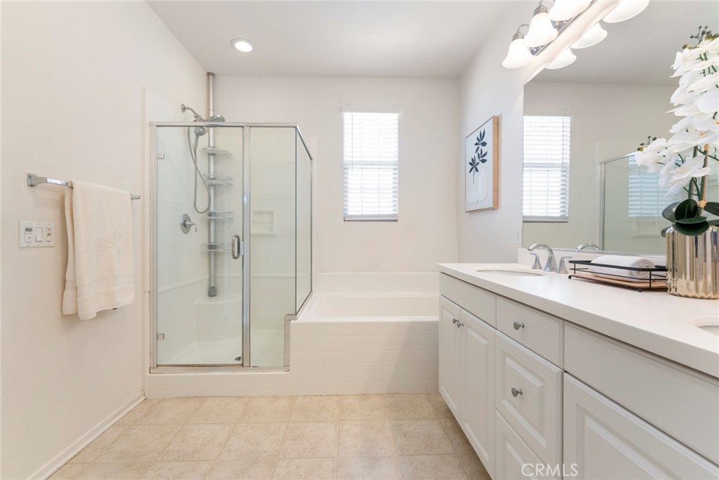 869 East Mountain Way, Unit D Azusa, CA 91702 - Photo 19 of 55 a bathroom with a tub sink shower and mirror