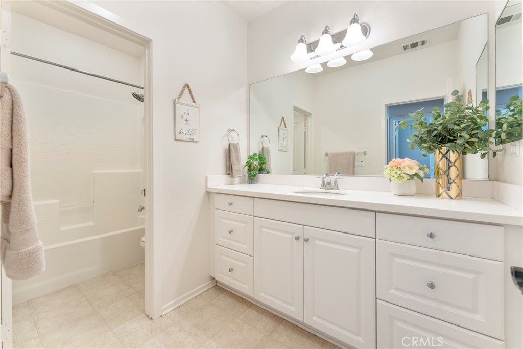 869 East Mountain Way, Unit D Azusa, CA 91702 - Photo 23 of 55 a bathroom with a sink mirror and a bathtub