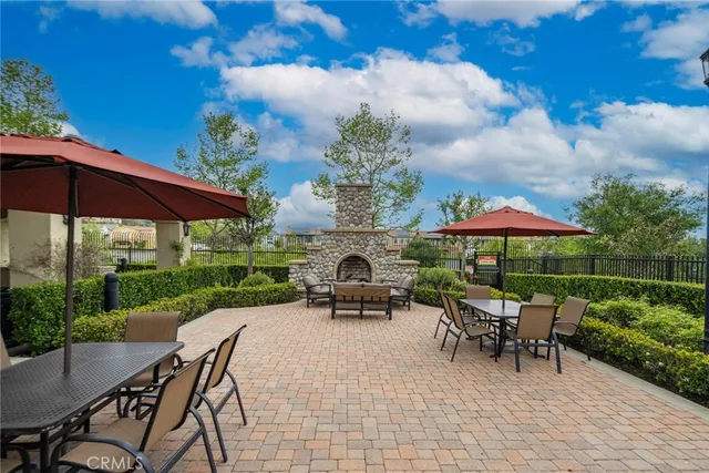 a view of patio with table and chairs under an umbrella