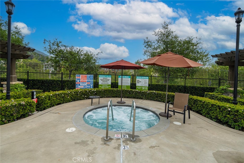 869 East Mountain Way, Unit D Azusa, CA 91702 - Photo 48 of 55 a view of patio with table and chairs under an umbrella