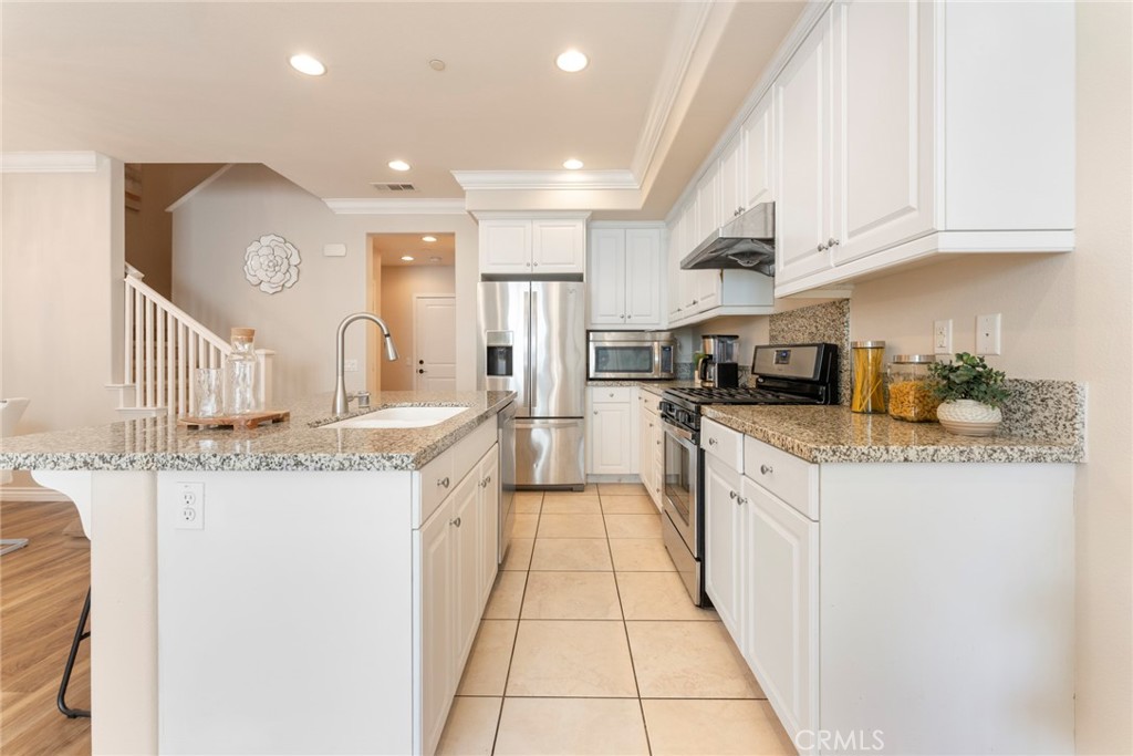 869 East Mountain Way, Unit D Azusa, CA 91702 - Photo 10 of 55 a large kitchen with stainless steel appliances granite countertop a sink and cabinets