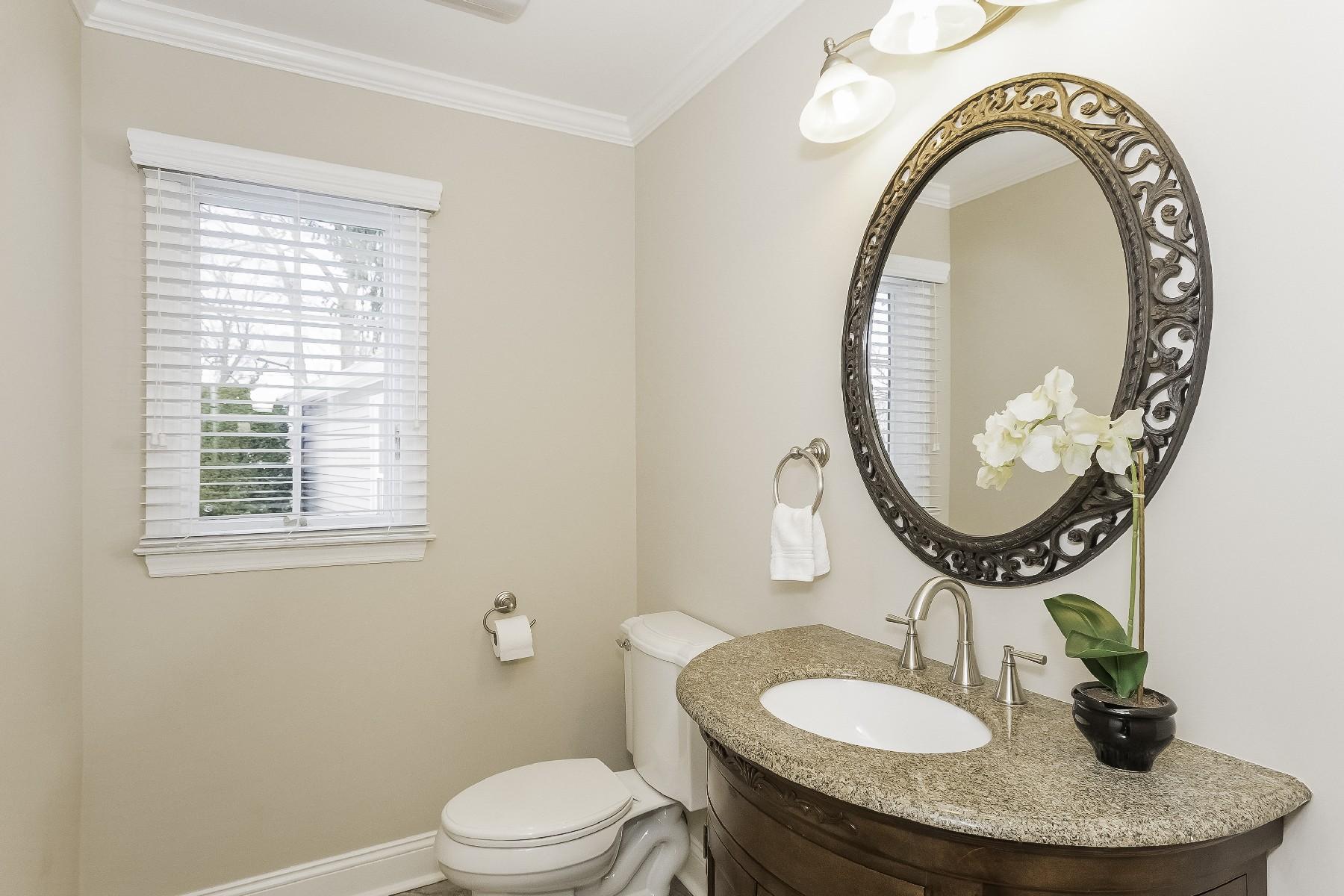 2 Tod Road Norwalk, CT 06851 - Photo 14 of 26 a bathroom with a toilet a sink a mirror and a window