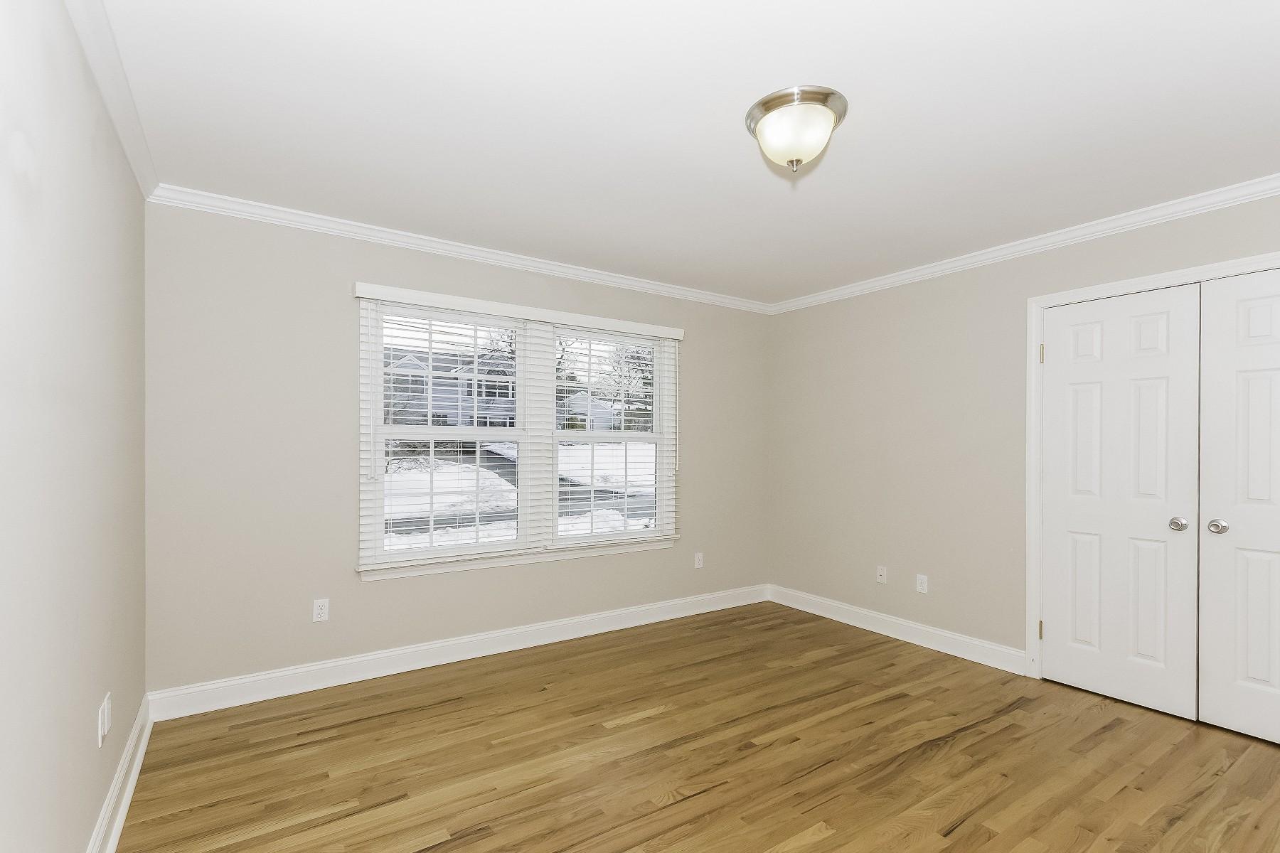 2 Tod Road Norwalk, CT 06851 - Photo 21 of 26 a view of an empty room with wooden floor and a window