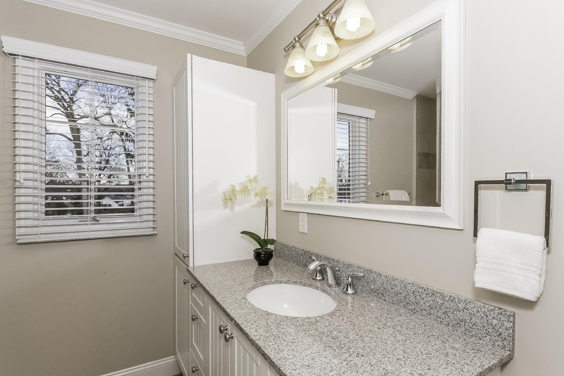 2 Tod Road Norwalk, CT 06851 - Photo 22 of 26 a bathroom with a granite countertop sink and a mirror