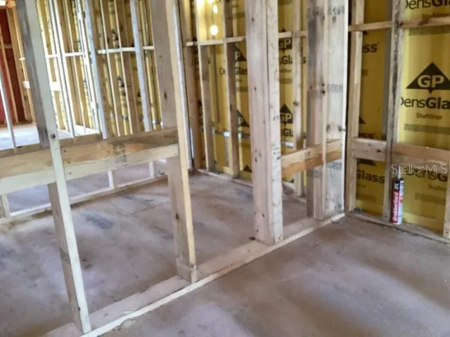 an empty room with floor to ceiling windows