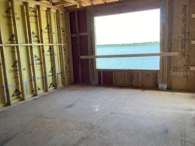 a view of a hallway with wooden walls