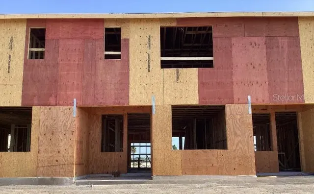 a view of a street sign on a wall next to a lake