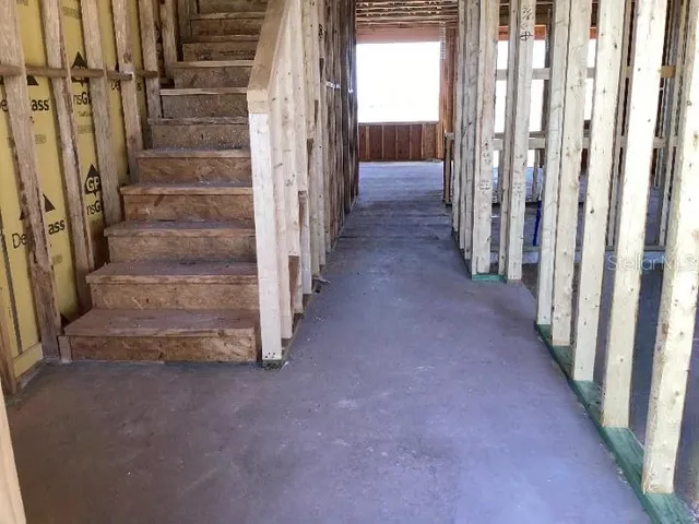 a view of a hallway with wooden floor and entryway