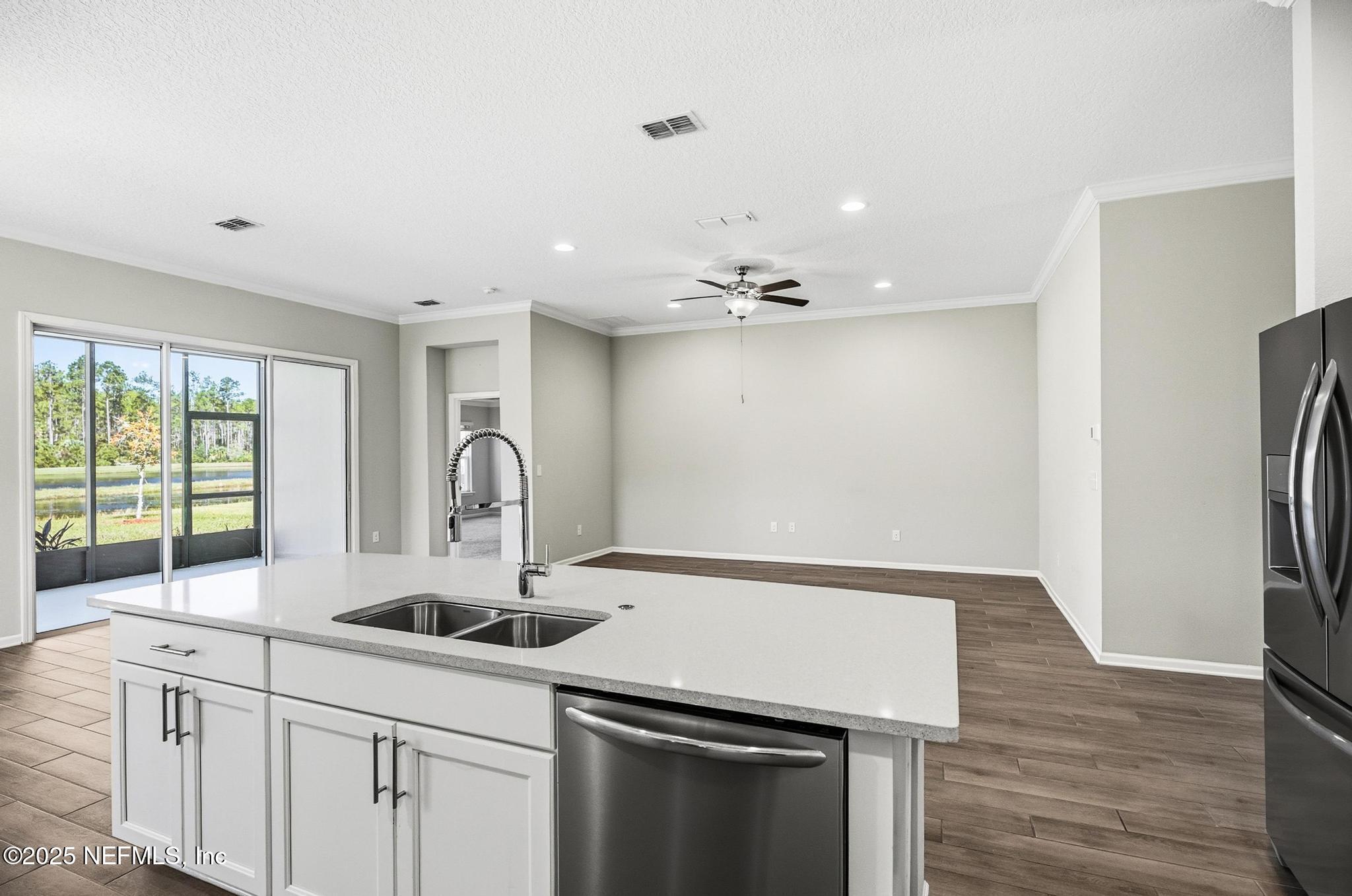 83 Hummingbird Court Palm Coast, FL 32164 - Photo 12 of 70 a kitchen with a sink cabinets and wooden floor