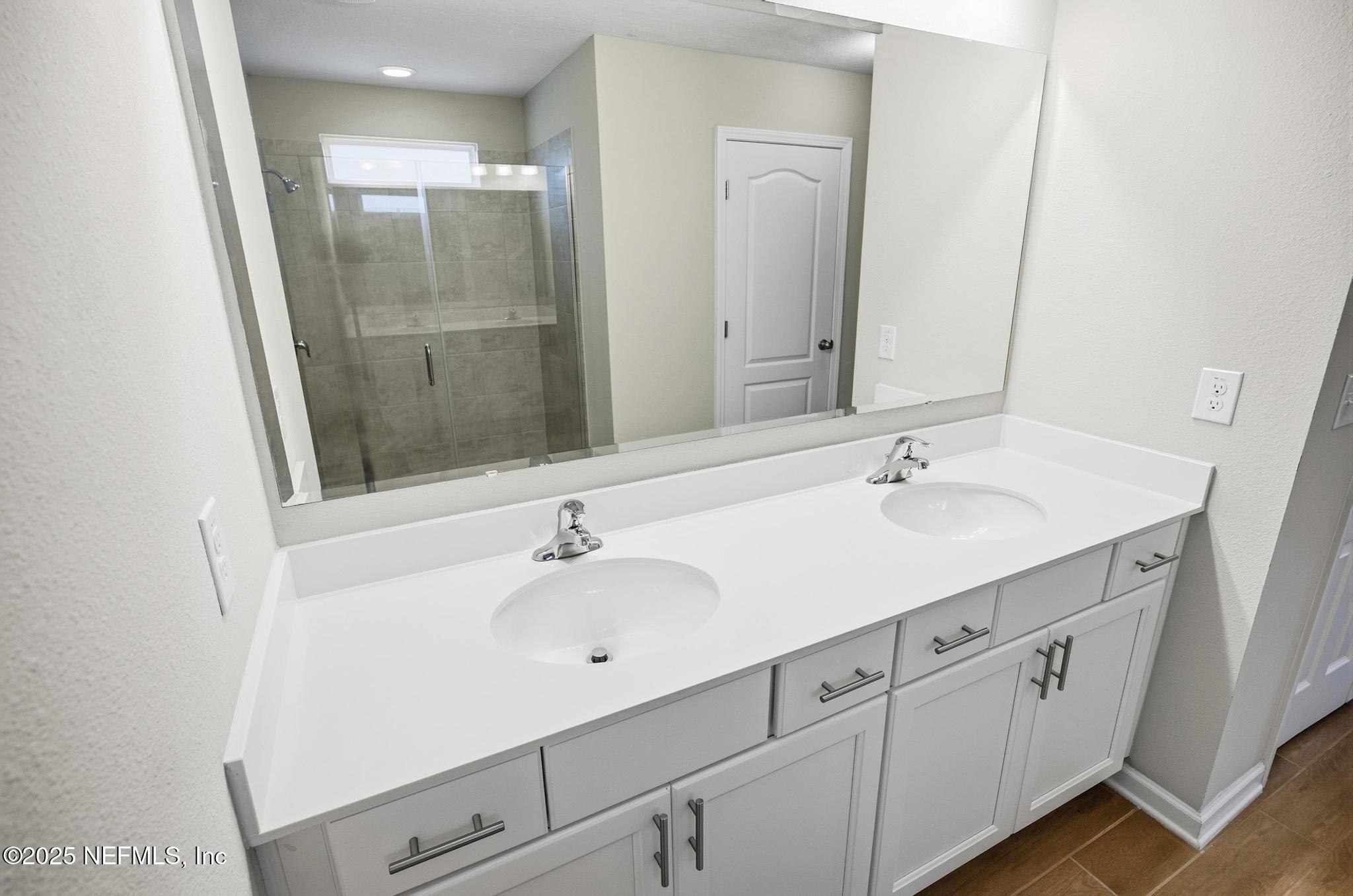 83 Hummingbird Court Palm Coast, FL 32164 - Photo 17 of 70 a bathroom with a sink and a mirror