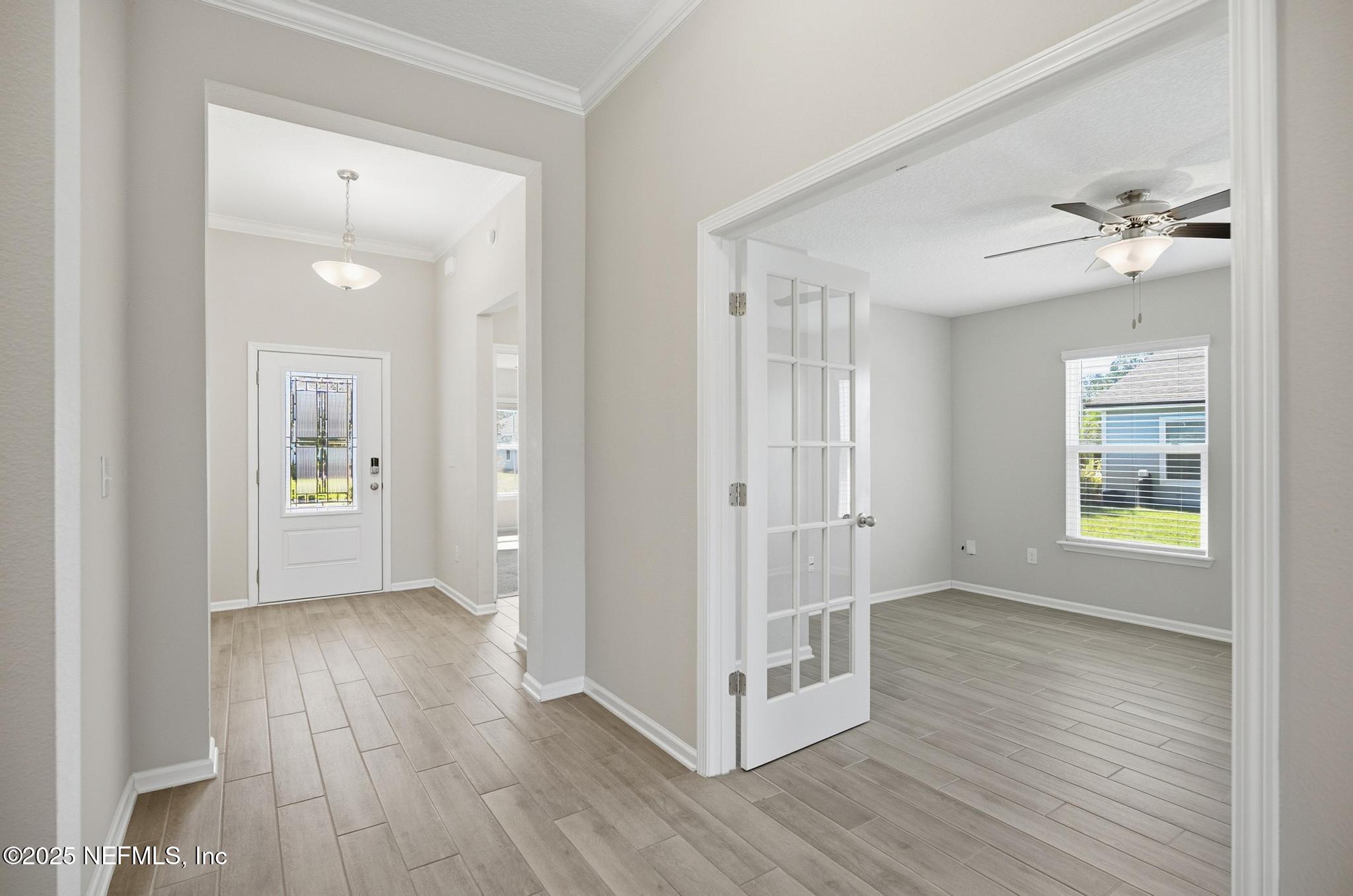 83 Hummingbird Court Palm Coast, FL 32164 - Photo 28 of 70 wooden floor in an empty room with a window