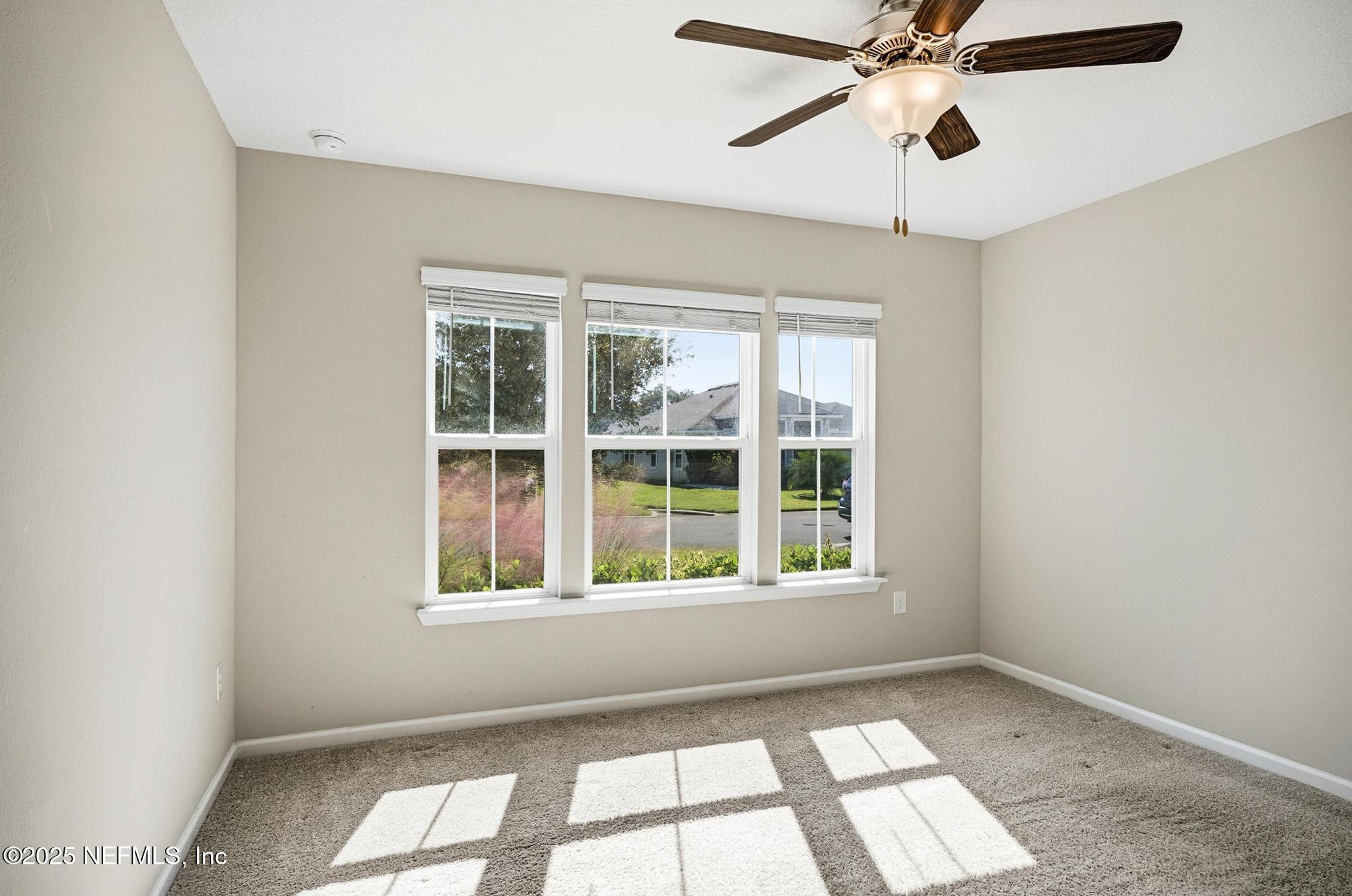 83 Hummingbird Court Palm Coast, FL 32164 - Photo 34 of 70 an empty room with a window and a fan
