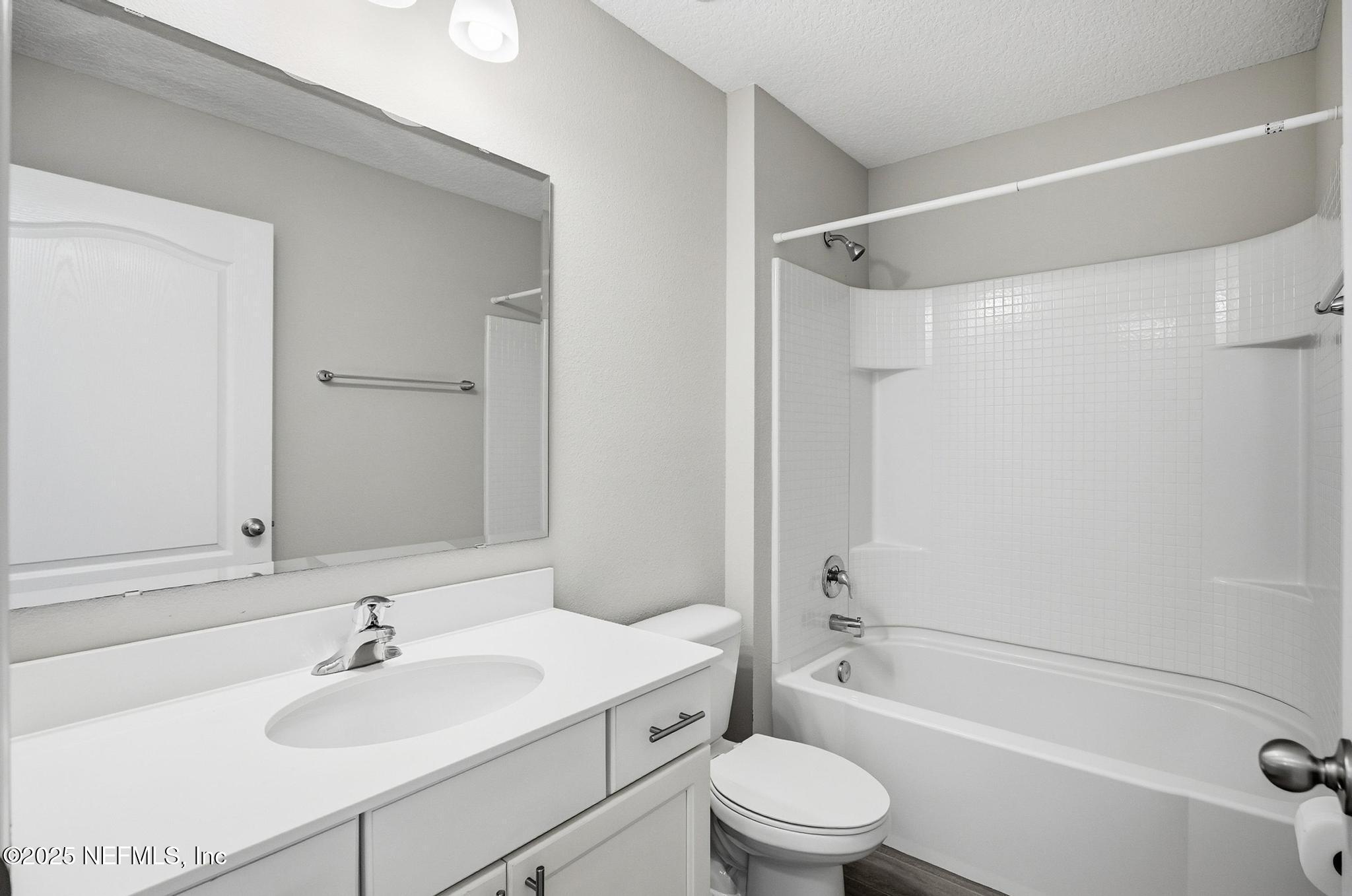83 Hummingbird Court Palm Coast, FL 32164 - Photo 37 of 70 a bathroom with a sink toilet and shower