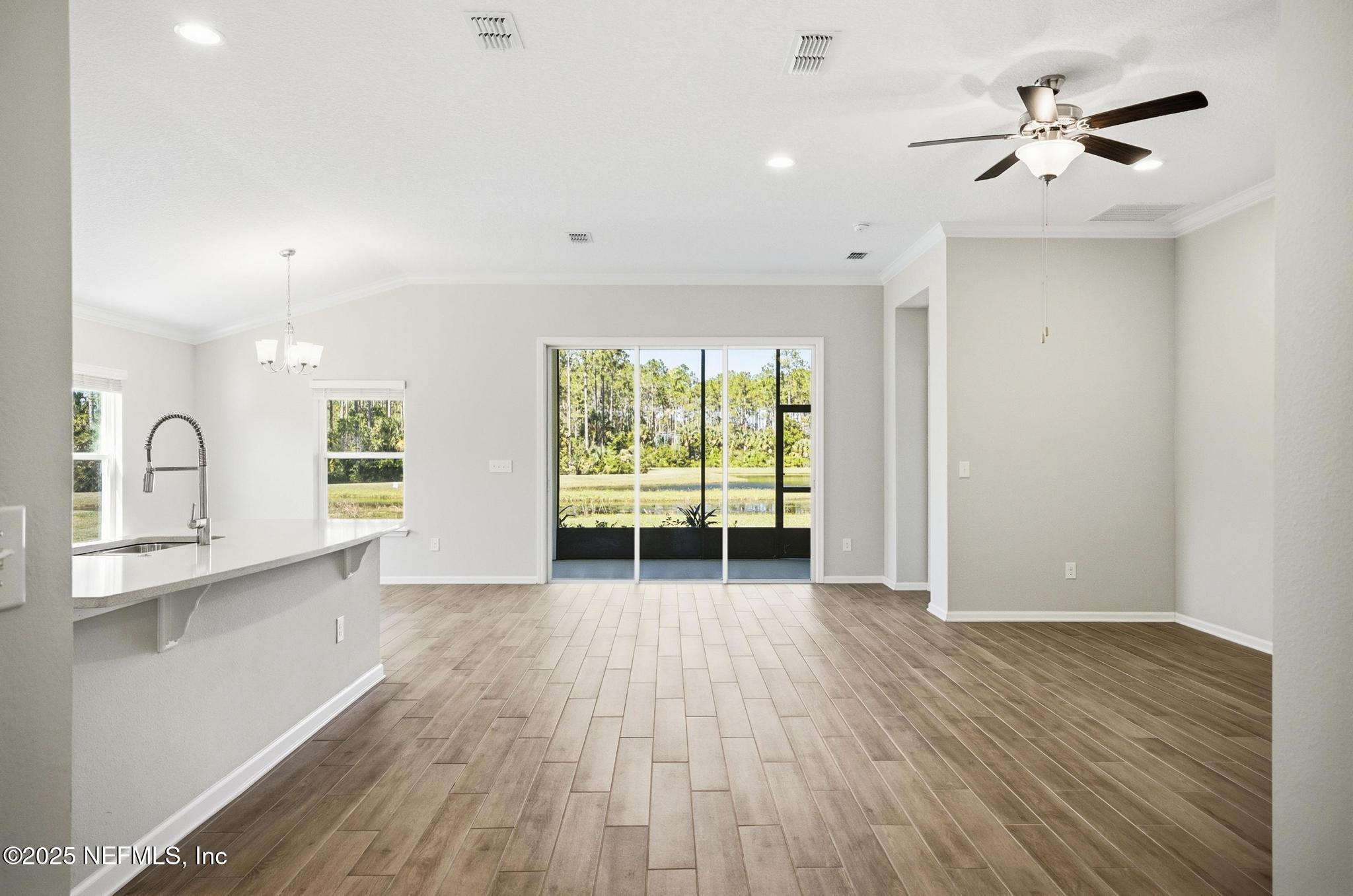 83 Hummingbird Court Palm Coast, FL 32164 - Photo 41 of 70 a view of an empty room with window and wooden floor