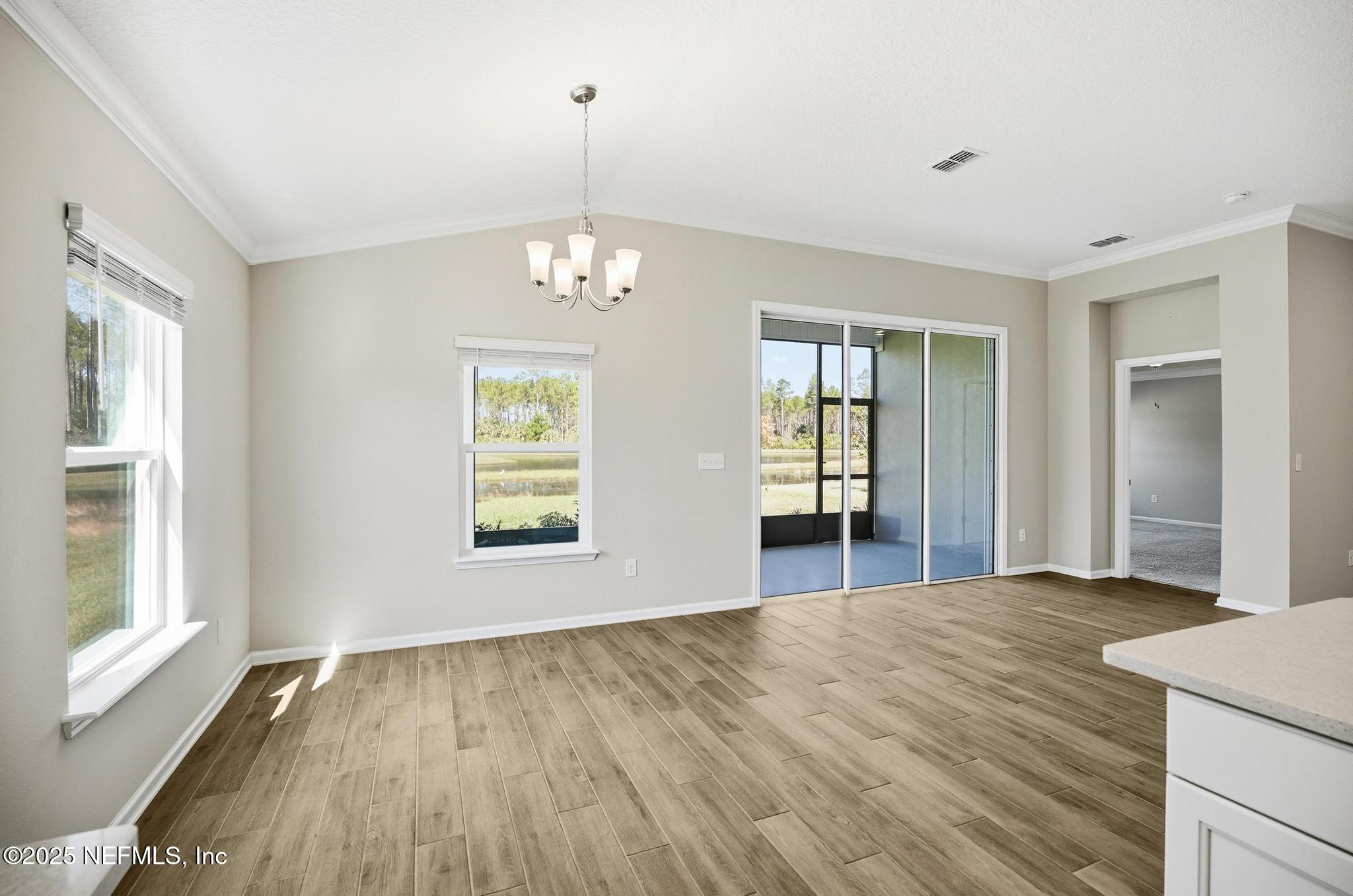 83 Hummingbird Court Palm Coast, FL 32164 - Photo 46 of 70 a view of an empty room with window and wooden floor