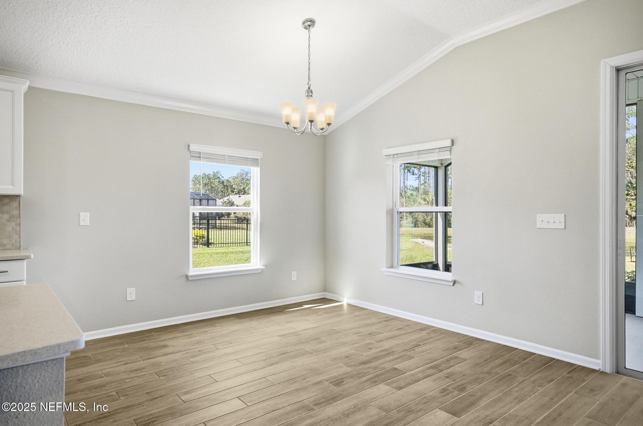 83 Hummingbird Court Palm Coast, FL 32164 - Photo 47 of 70 a view of an empty room with a window and wooden floor