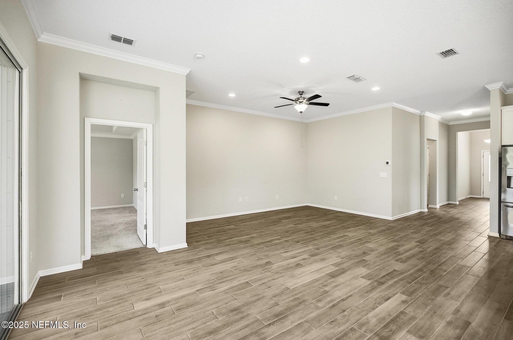 83 Hummingbird Court Palm Coast, FL 32164 - Photo 48 of 70 wooden floor in an empty room with a window