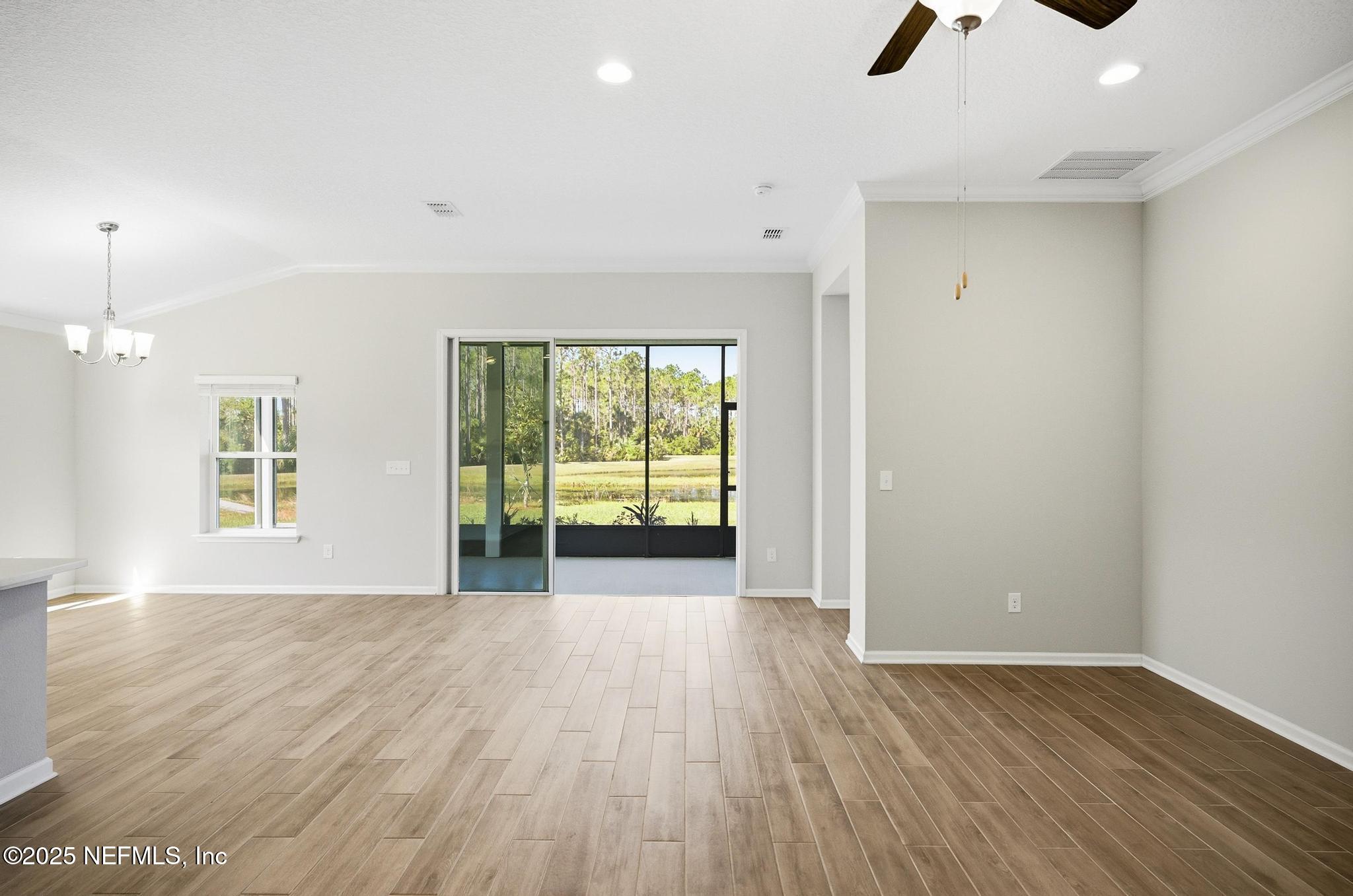 83 Hummingbird Court Palm Coast, FL 32164 - Photo 49 of 70 an empty room with wooden floor and windows