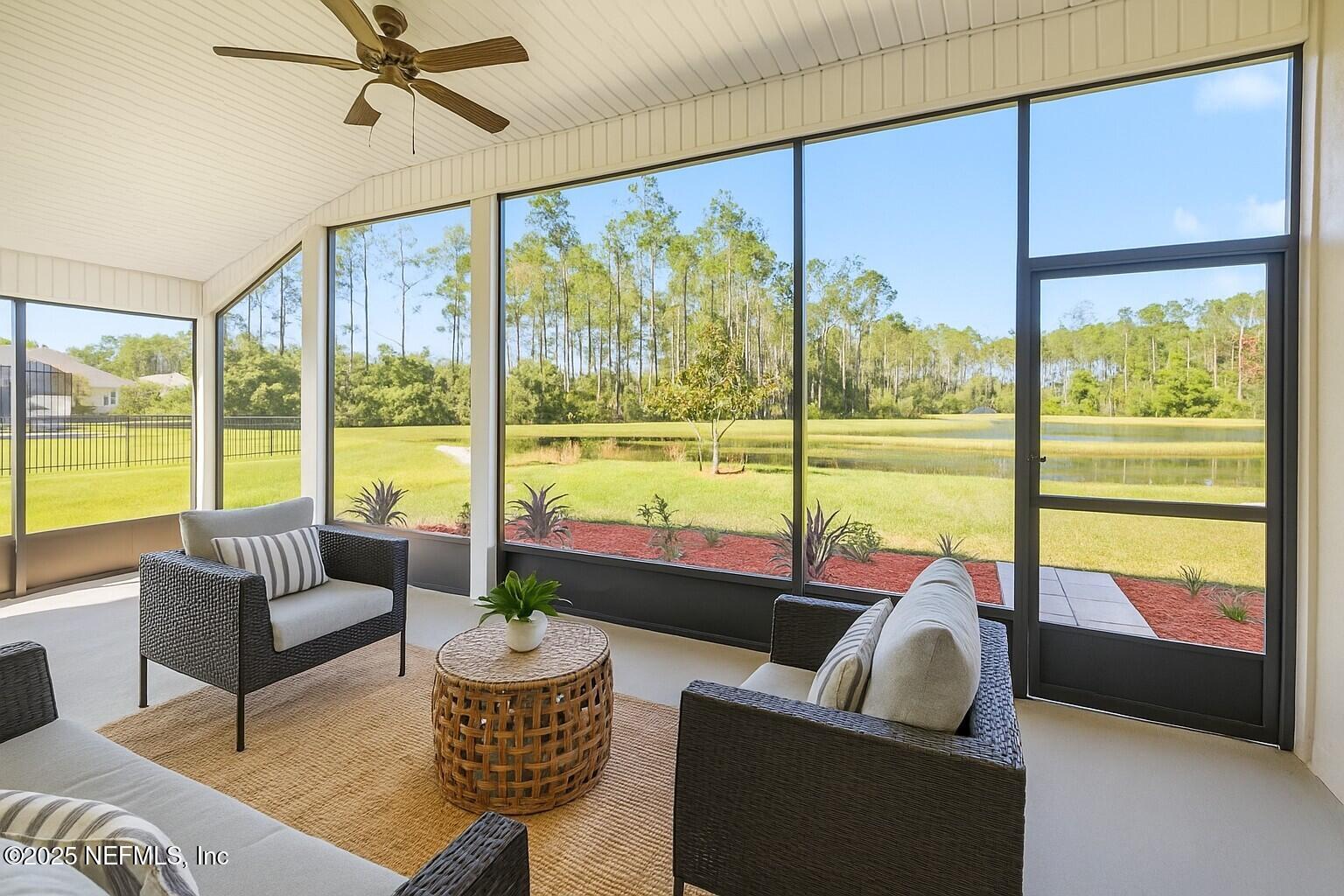 83 Hummingbird Court Palm Coast, FL 32164 - Photo 52 of 70 a living room with furniture and a large window