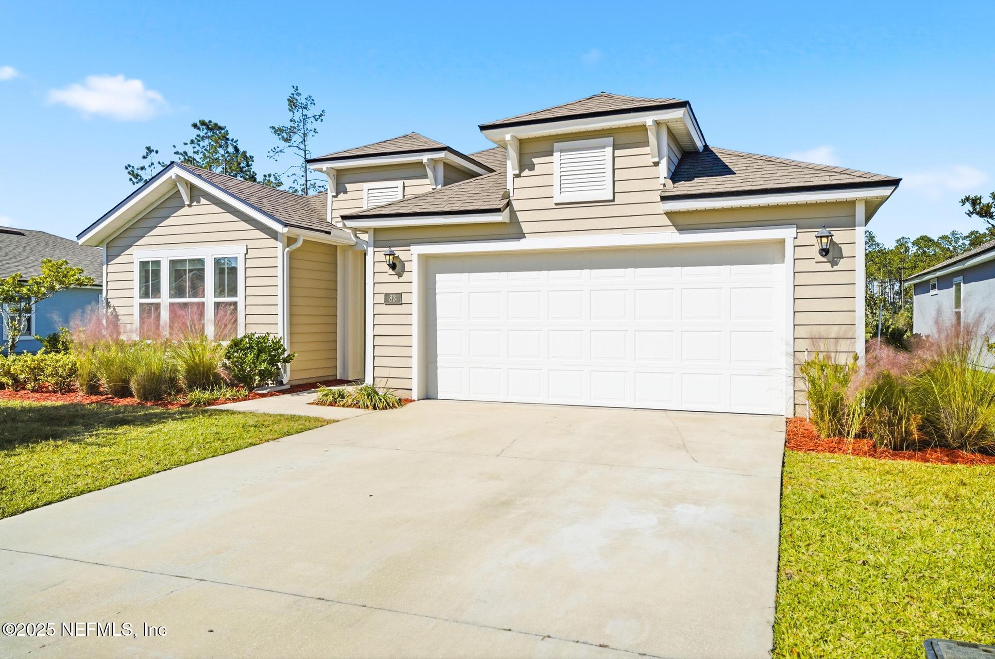 83 Hummingbird Court Palm Coast, FL 32164 - Photo 54 of 70 a front view of a house with a yard