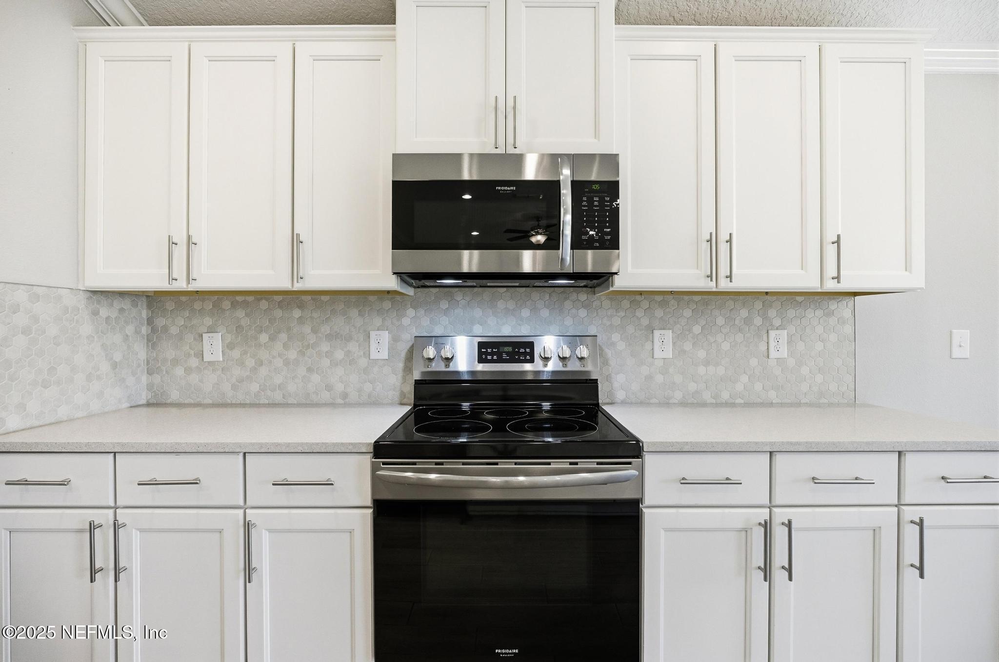 83 Hummingbird Court Palm Coast, FL 32164 - Photo 6 of 70 a kitchen with stainless steel appliances granite countertop white cabinets and a stove