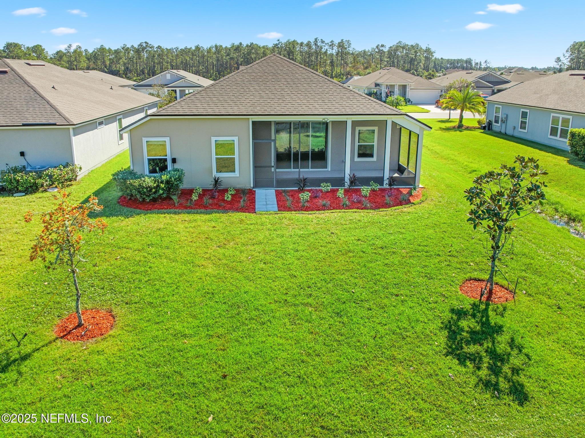 83 Hummingbird Court Palm Coast, FL 32164 - Photo 63 of 70 a front view of house with yard and green space
