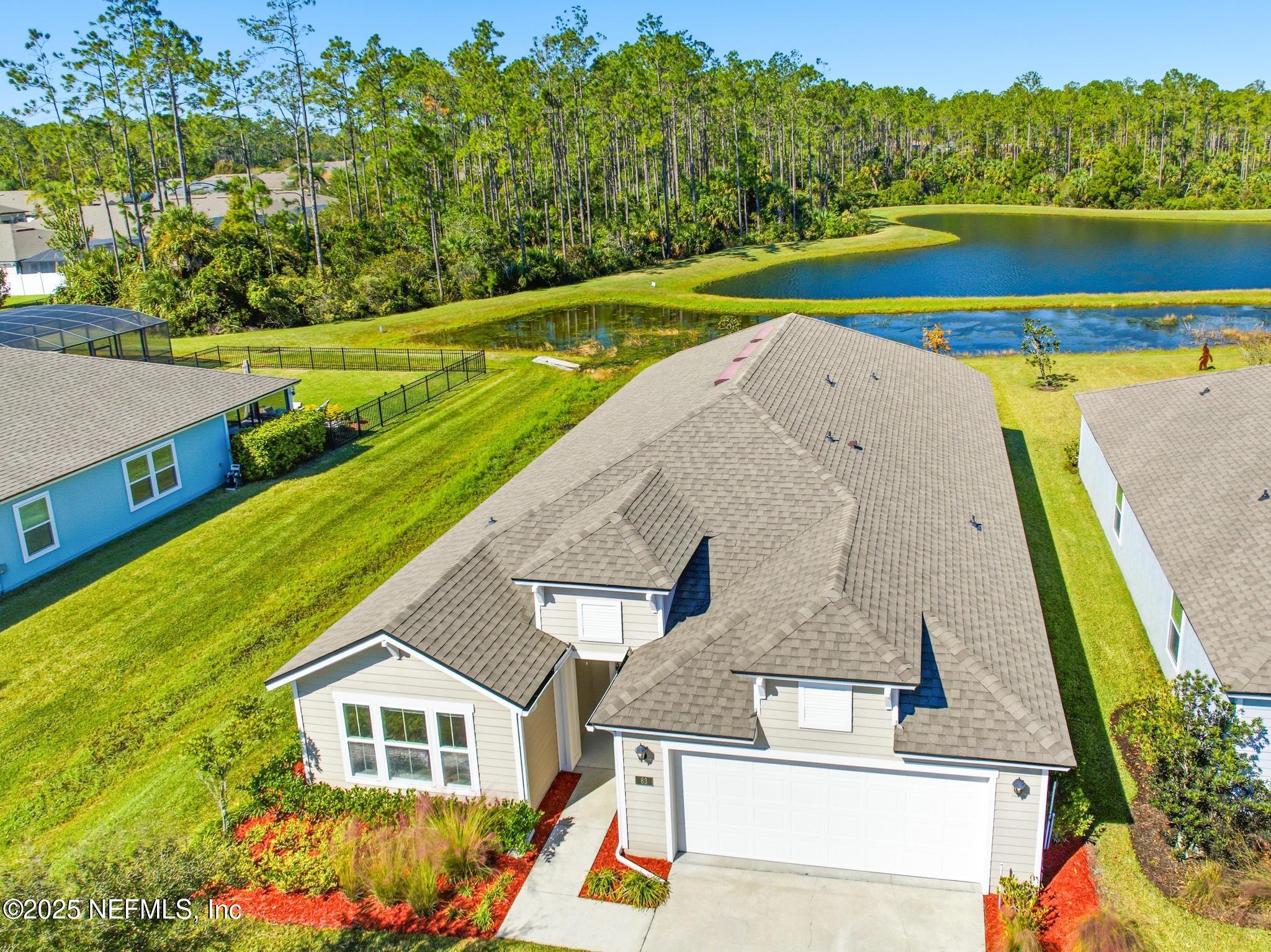 83 Hummingbird Court Palm Coast, FL 32164 - Photo 64 of 70 a view of swimming pool with a yard and large tree