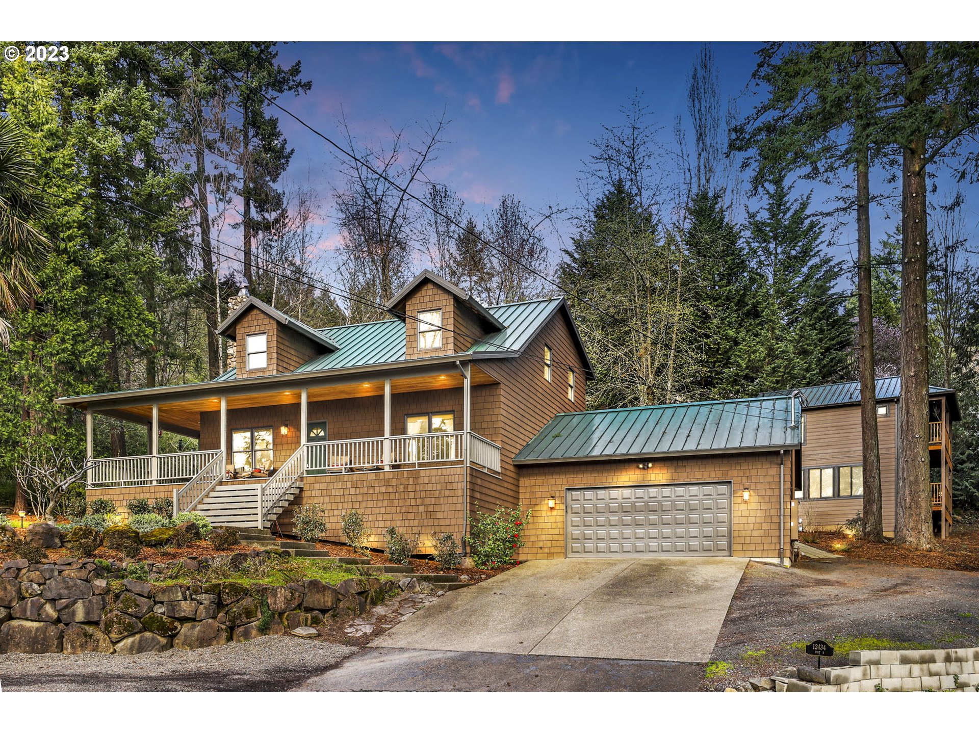 12434 Southwest 57th Avenue Portland, OR 97219 - Photo 1 of 34 a front view of a house with garden
