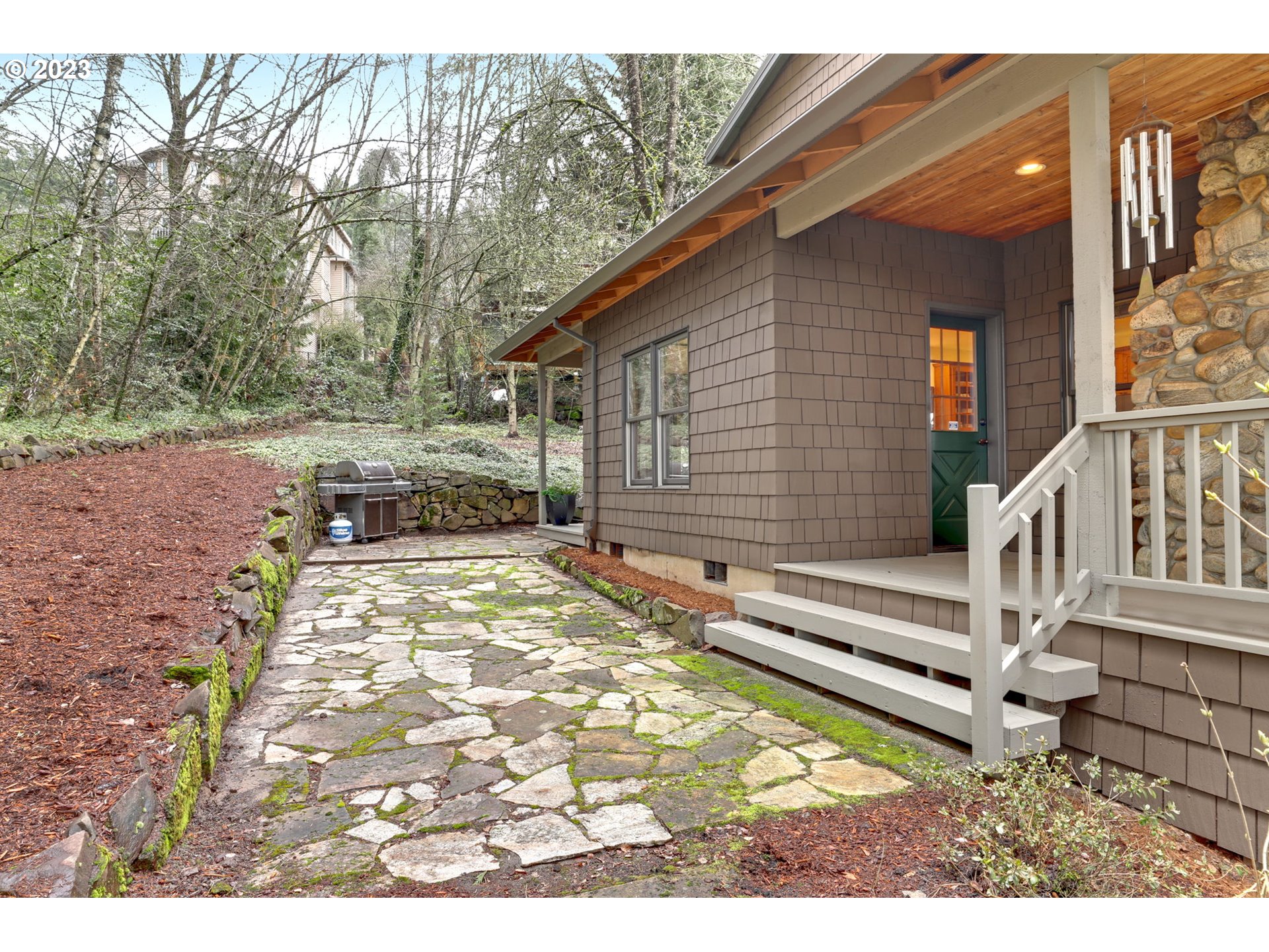 12434 Southwest 57th Avenue Portland, OR 97219 - Photo 13 of 34 a backyard of a house with table and chairs