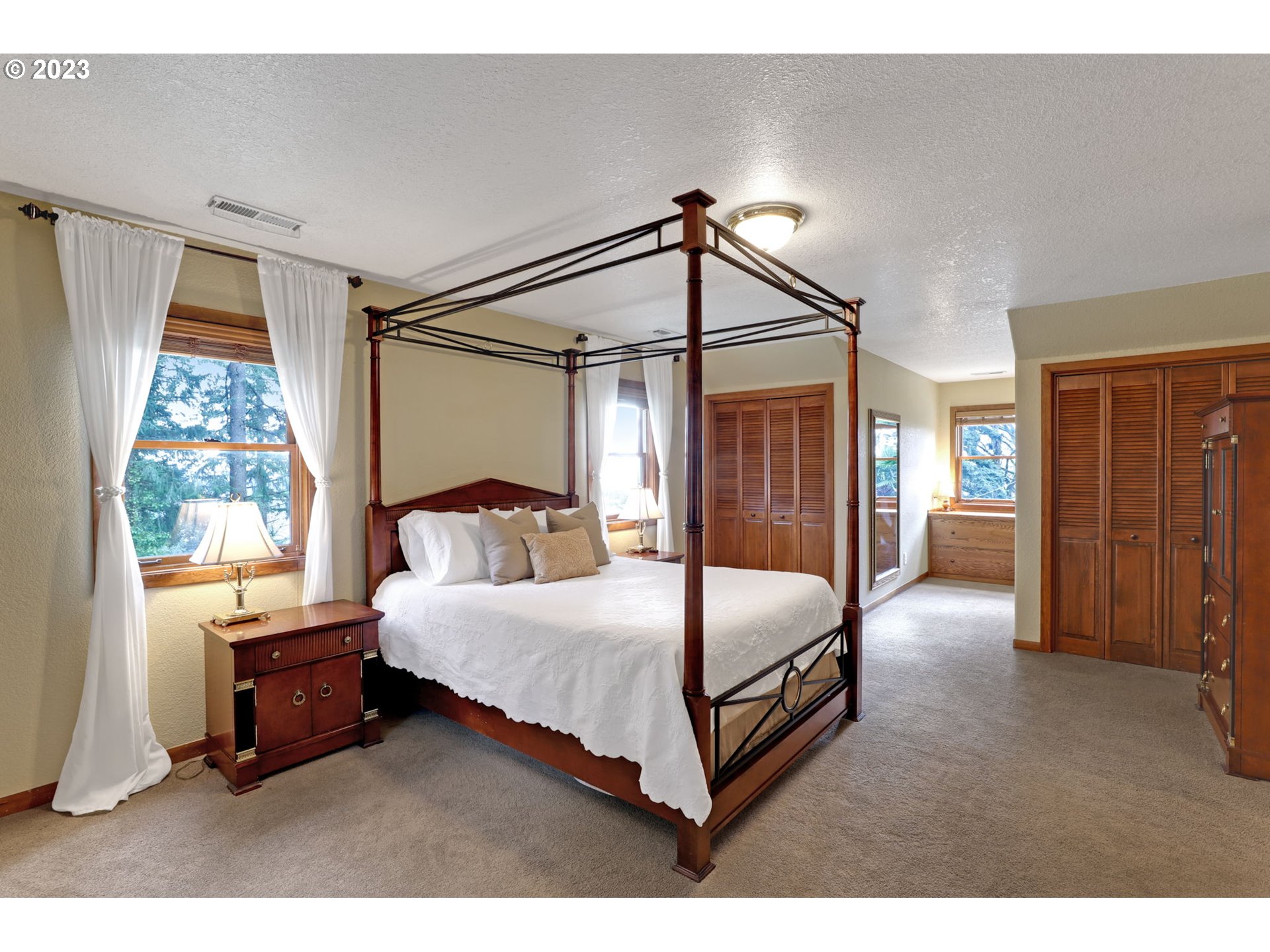 12434 Southwest 57th Avenue Portland, OR 97219 - Photo 15 of 34 a bedroom with a bed and a window