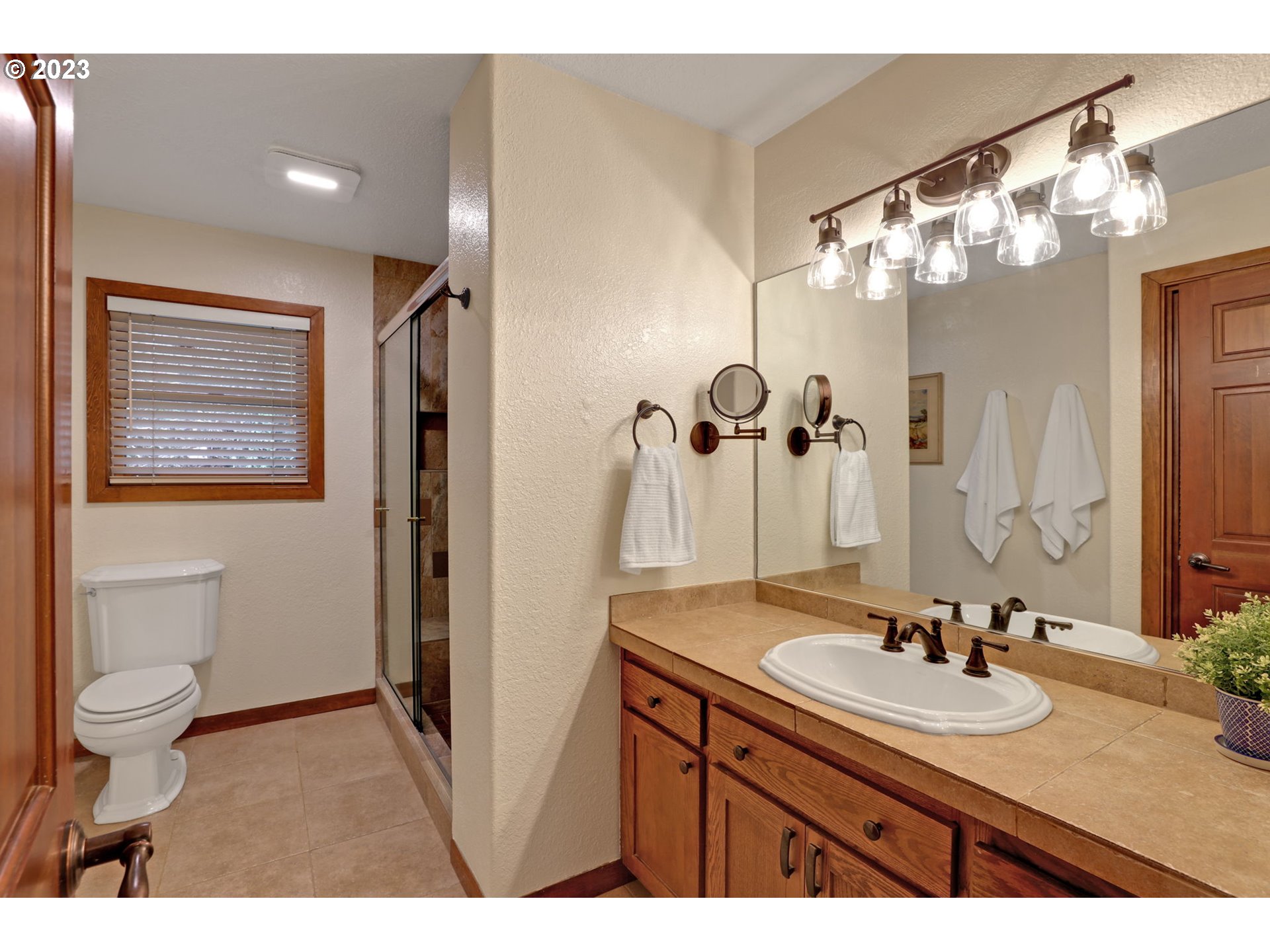 12434 Southwest 57th Avenue Portland, OR 97219 - Photo 17 of 34 a bathroom with a sink double vanity and a mirror