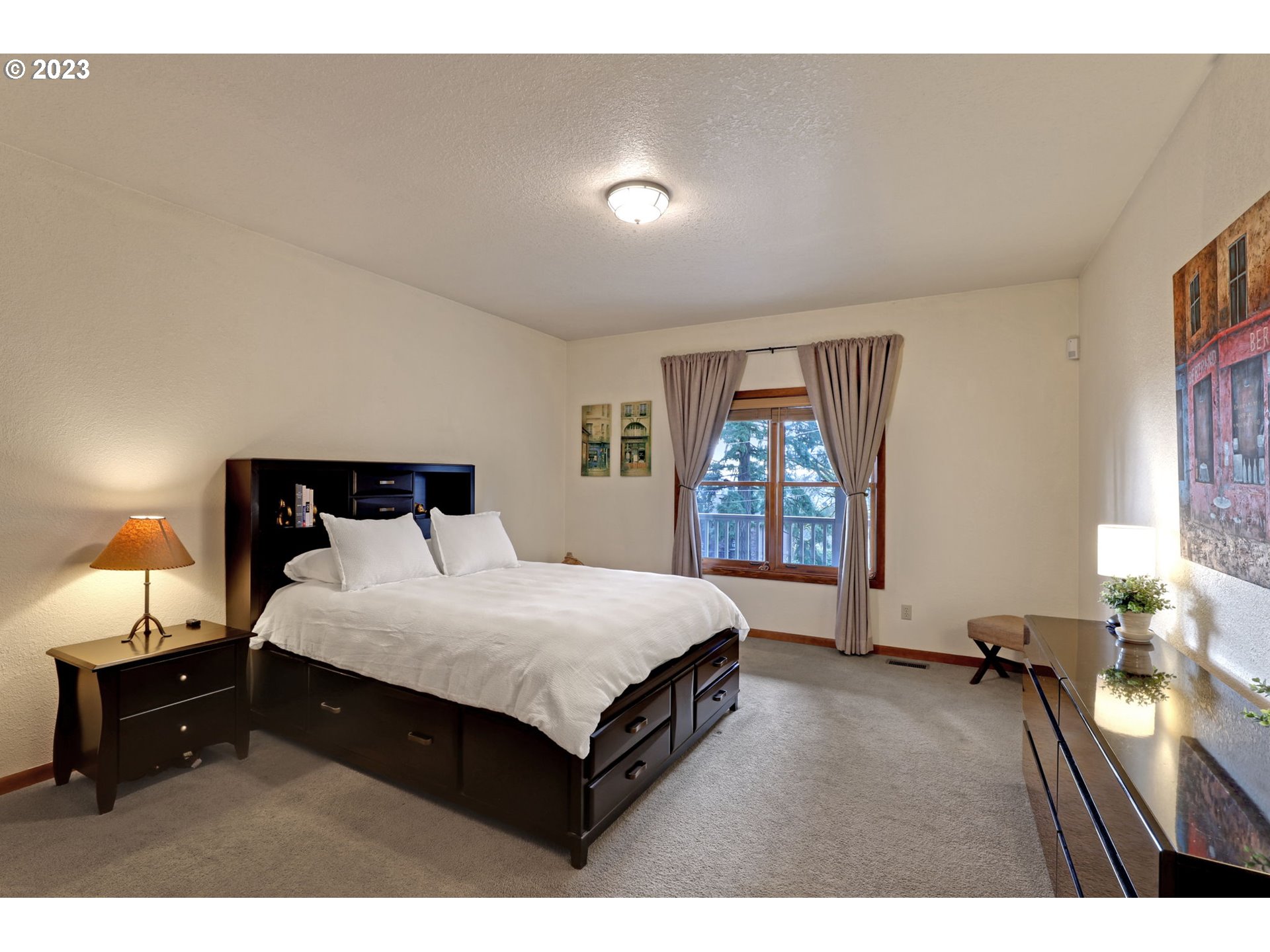 12434 Southwest 57th Avenue Portland, OR 97219 - Photo 20 of 34 a bedroom with a bed and a large mirror