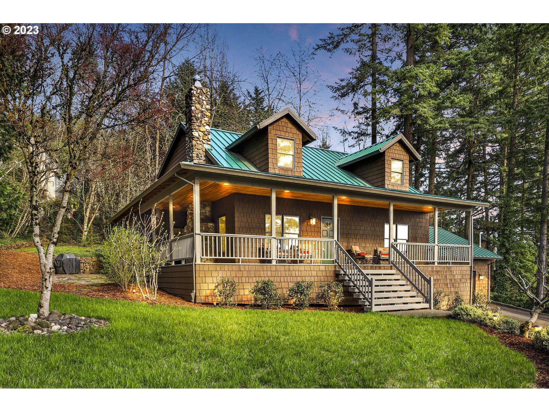 12434 Southwest 57th Avenue Portland, OR 97219 - Photo 2 of 34 a front view of a house with a yard