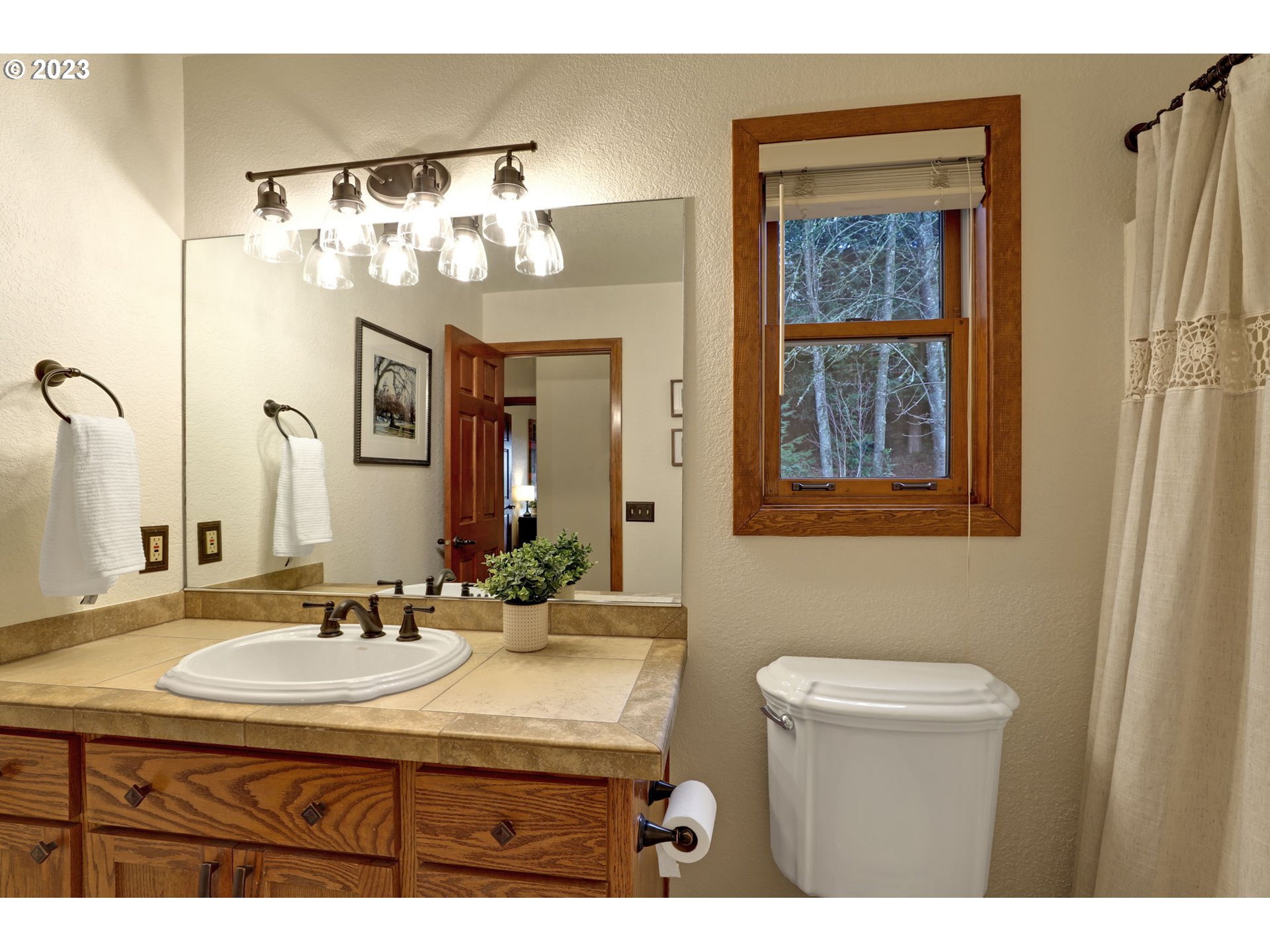 12434 Southwest 57th Avenue Portland, OR 97219 - Photo 21 of 34 a bathroom with a sink vanity and a mirror