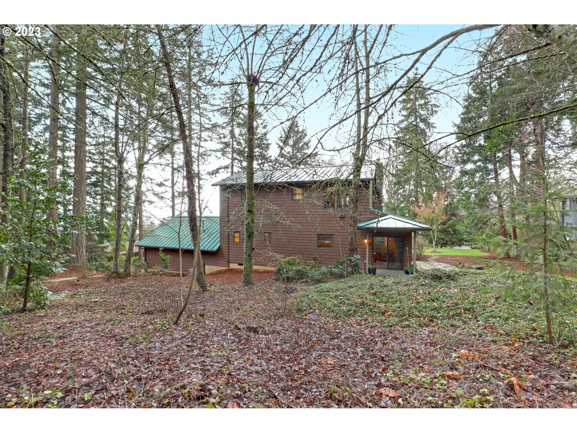 12434 Southwest 57th Avenue Portland, OR 97219 - Photo 23 of 34 a backyard of a house with lots of green space