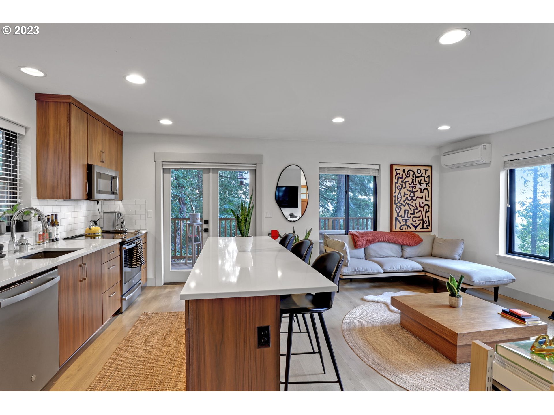 12434 Southwest 57th Avenue Portland, OR 97219 - Photo 27 of 34 a living room with furniture and a flat screen tv