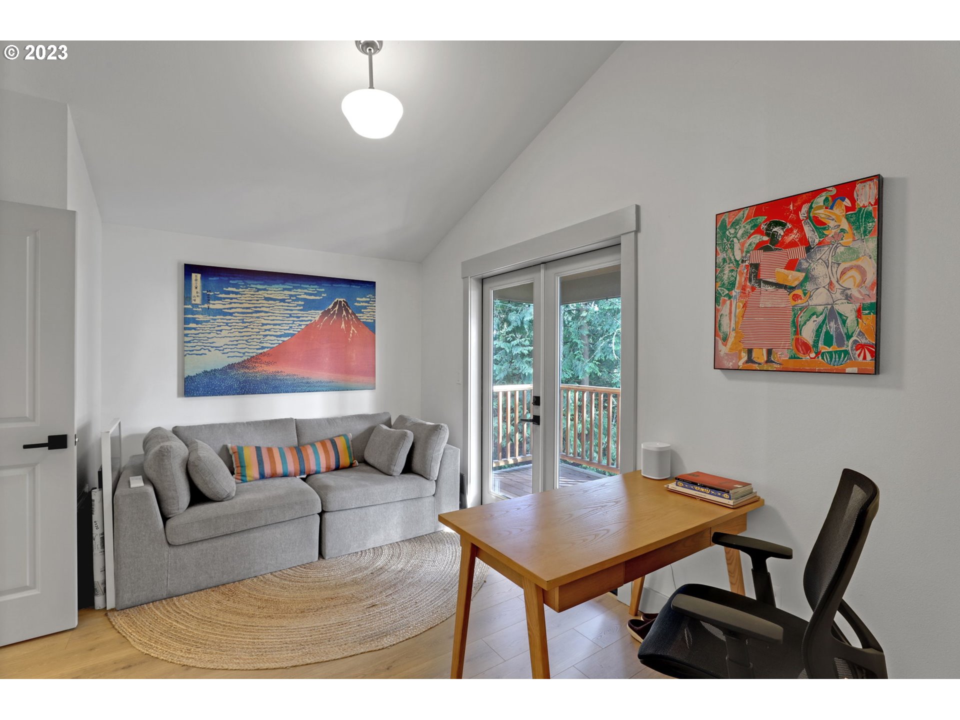 12434 Southwest 57th Avenue Portland, OR 97219 - Photo 29 of 34 a living room with furniture a dining table and paintings on the wall